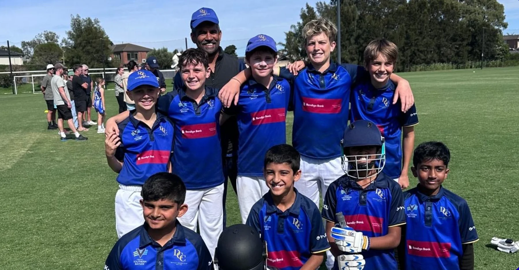 Dingley junior team and coach on the oval