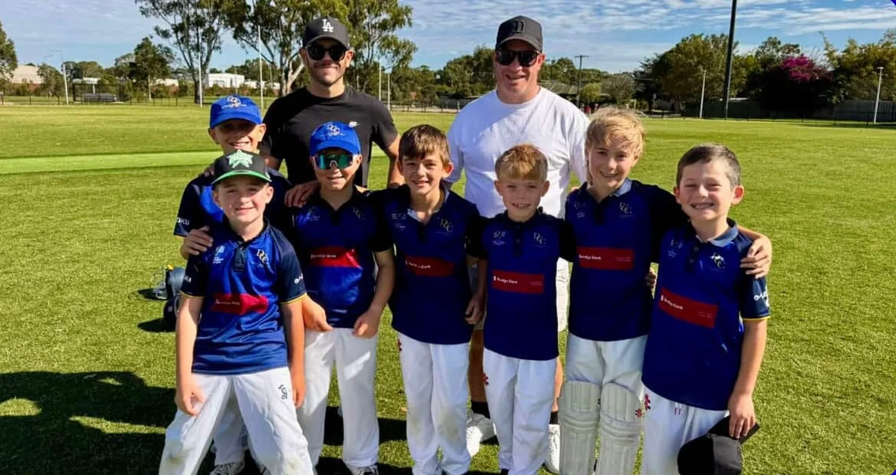 Dingley junior players and coaches on the oval